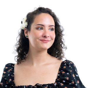 Head-shot of a young woman smiling away from the camera